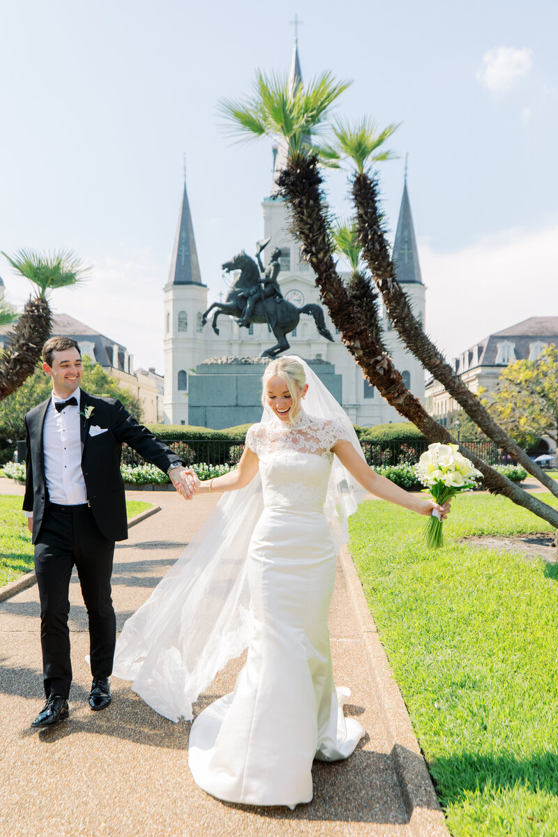 Bride and groom in Jackson Square New Orleans running