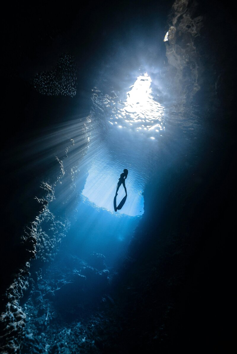 Image of a diver swimming in a sea cave