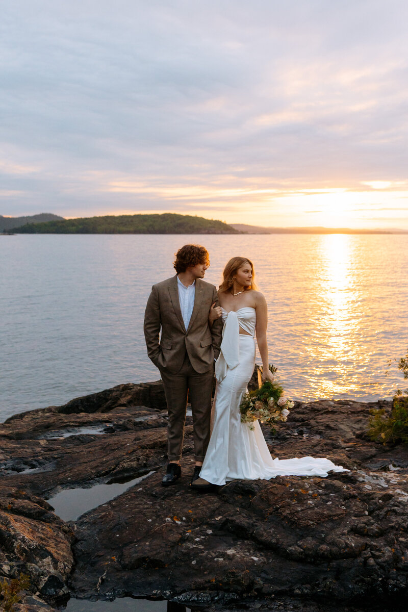 Bride and Groom overlooking lake superior during sunset