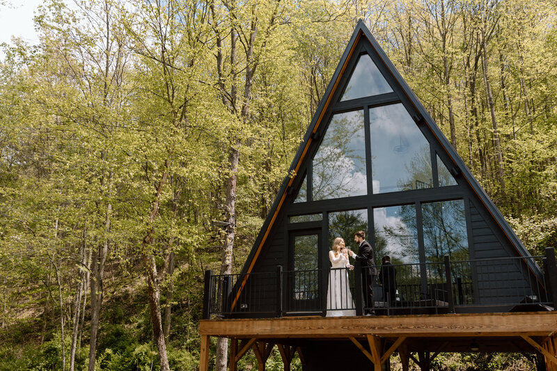 GIF of a bride and groom toasting with s'mores in front of a fire.