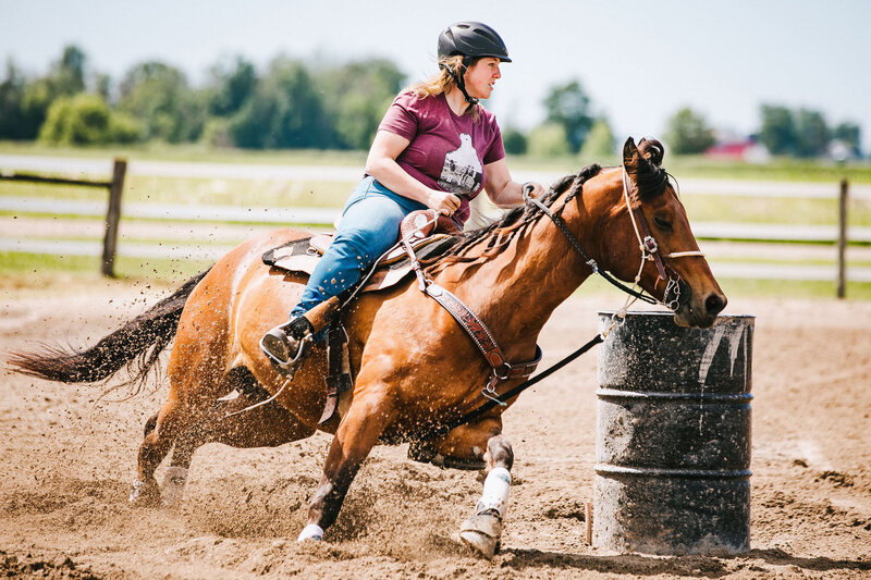 a girl riding her horse barrel racing