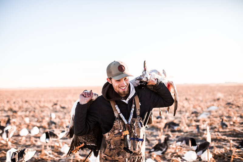 Hunting guide in Kansas carrying geese