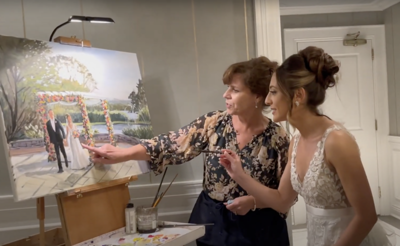 live painter Linda Marino showing bride ceremony painting