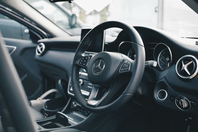 inside of a BMW car with steering wheel as main focus