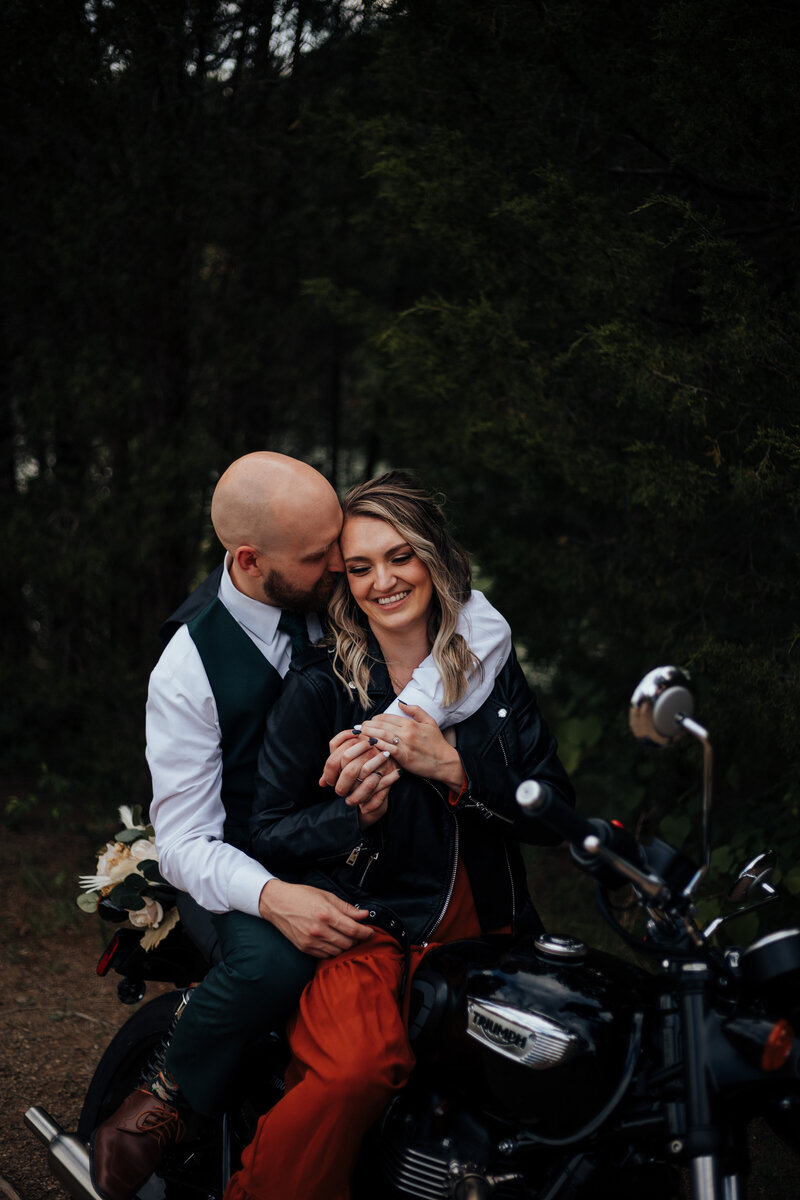 couple embracing on motorcycle