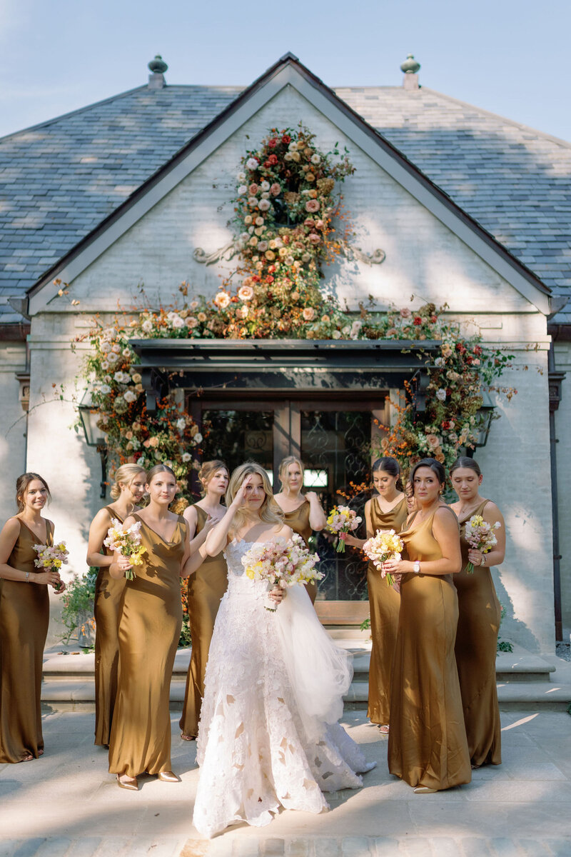 Organic growing floral installation for fall wedding ceremony backdrop. Private residence wedding build out for outdoor wedding ceremony and reception. Whimsical and organic floral design for autumnal wedding in colors of copper, yellow, blush, cream, and pops of orange. Clear tented wedding outside Nashville, TN. Design by Rosemary & Finch Floral Design in Nashville, TN. 