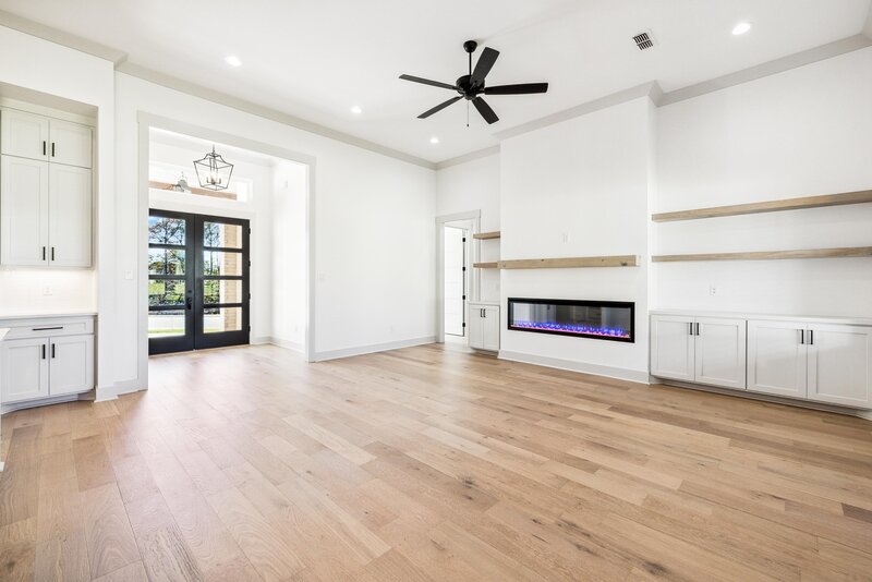Photo of a beautiful living room with white walls and hardwood floors.