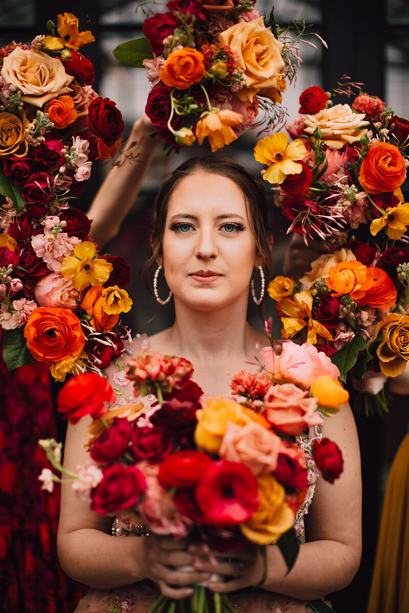 Bridesmaids hold bouquets to frame Bride during her Tinsmith Wedding