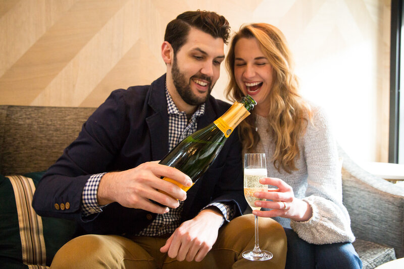 couple pouring champagne celebrating proposal at londonhouse chicago