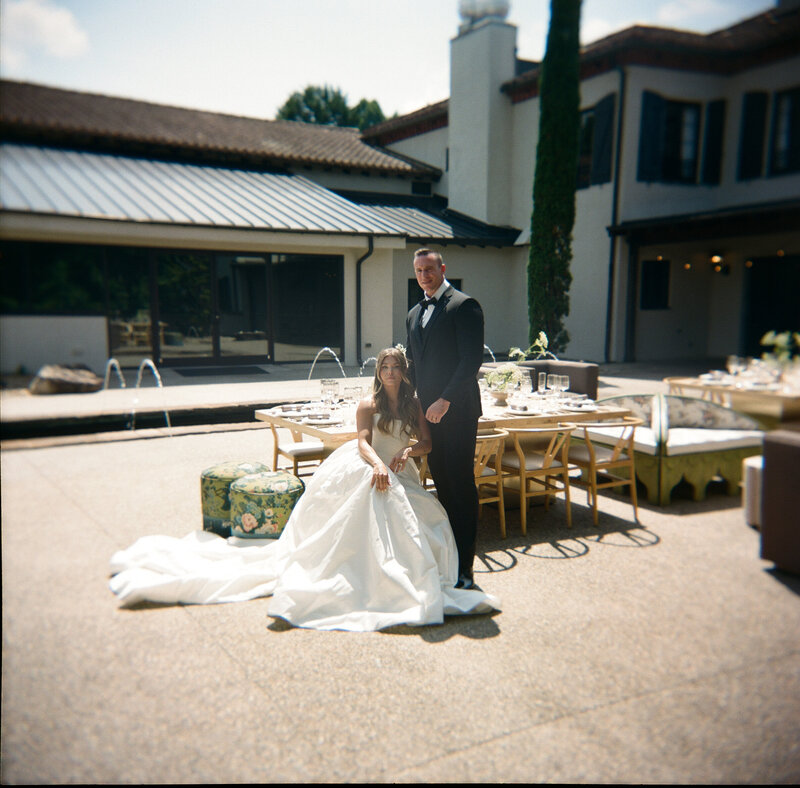 Couple embracing near the historic architecture of Hotel Domestique.