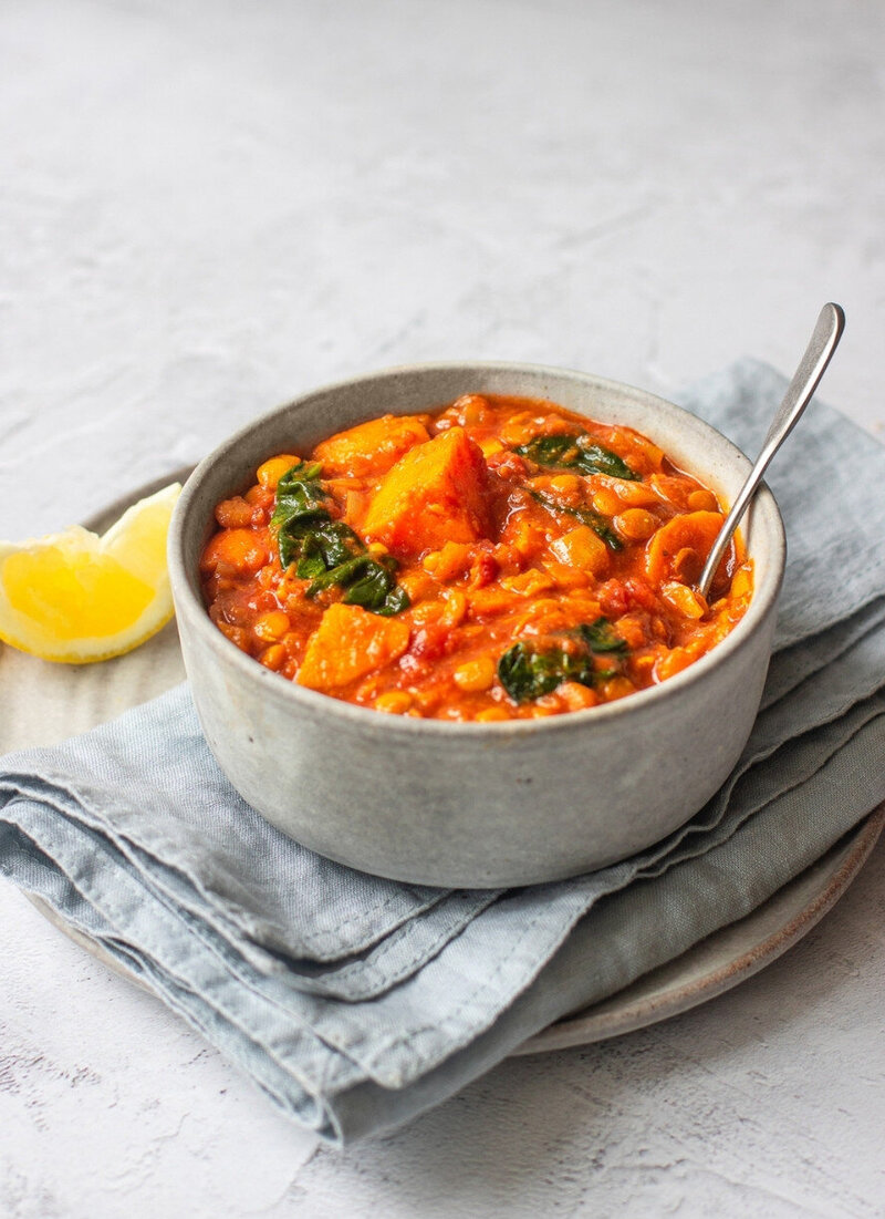 Hearty lentil and sweet potato curry served in a grey bowl — a nourishing hormone-balancing recipe from the 14-Day Perimenopause Meal Plan