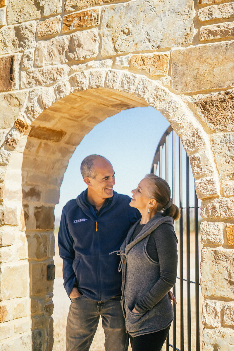 Bobby and Gail standing under a stone archway