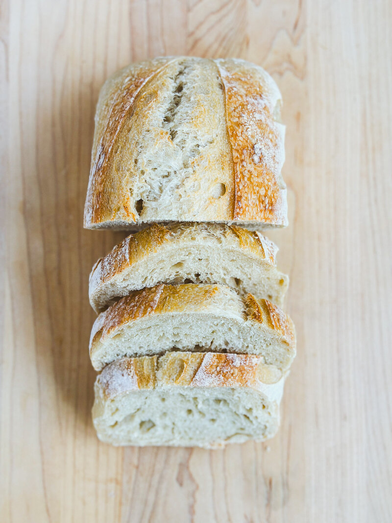 Close-up of freshly sliced sourdough bread from Mind Your Biscuits Bakeshop’s upcoming bread drop.