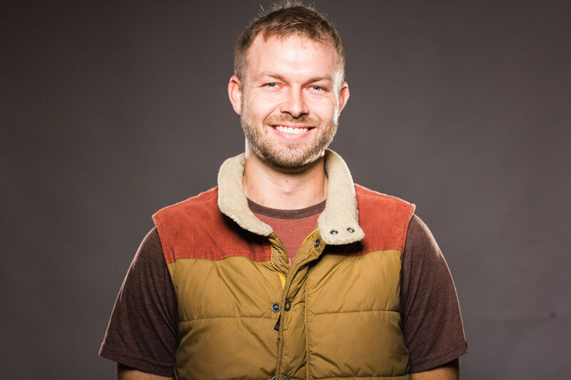 Jeremy Francis smiling wearing a colorful vest