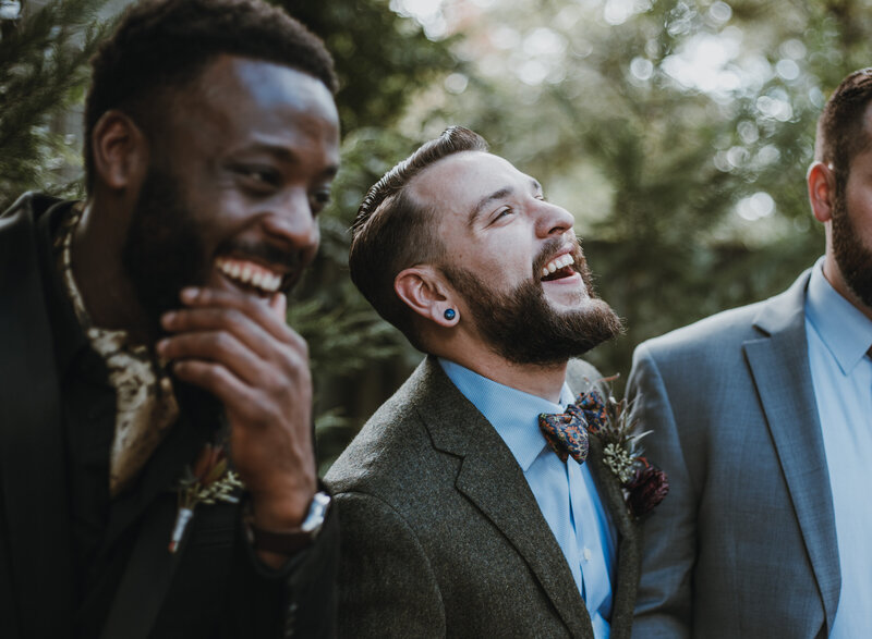 three groomsmen smiling
