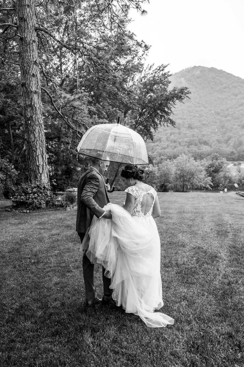 Married couple walking in the rain with umbrella