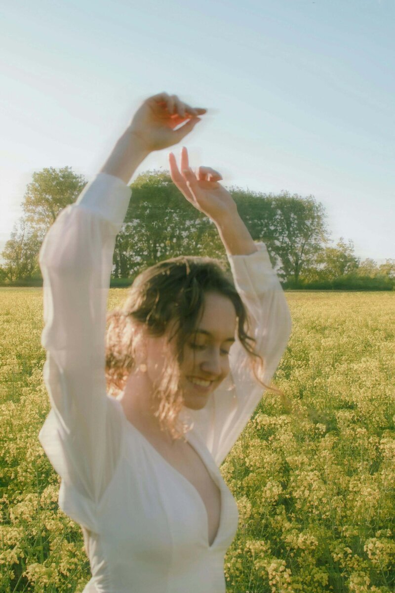 A woman dancing in a field 