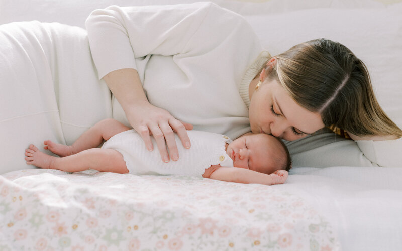 mom with newborn on bed