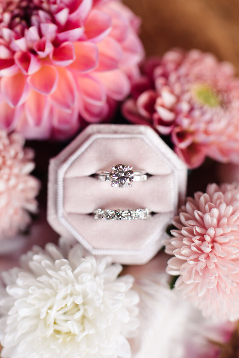 wedding rings by tiffany and co surrounded by pink flowers