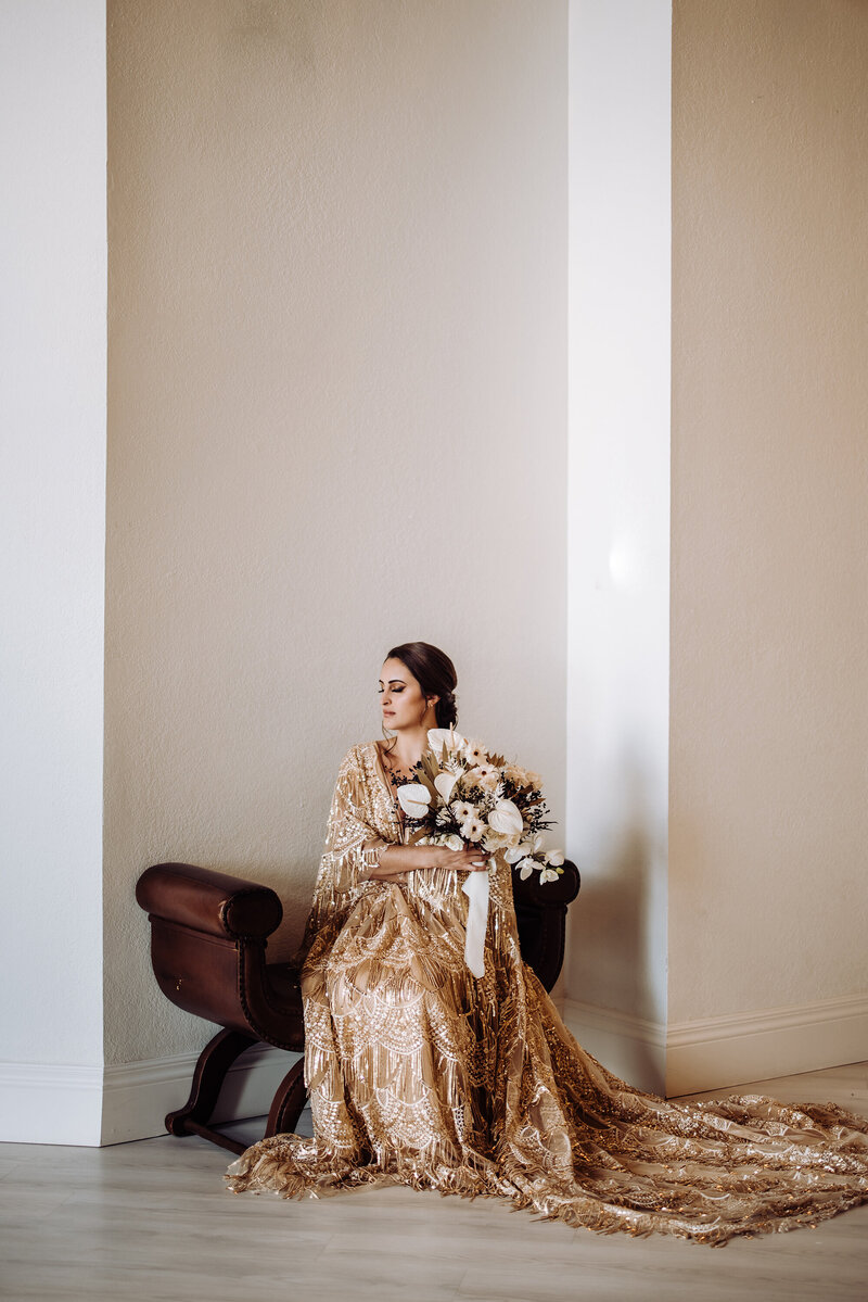 golden-beaded-bride-posed-elegantly