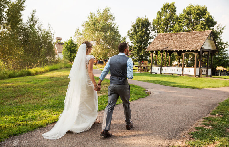 Walking to the Deer Creek Stables wedding reception at Chatfield Farms