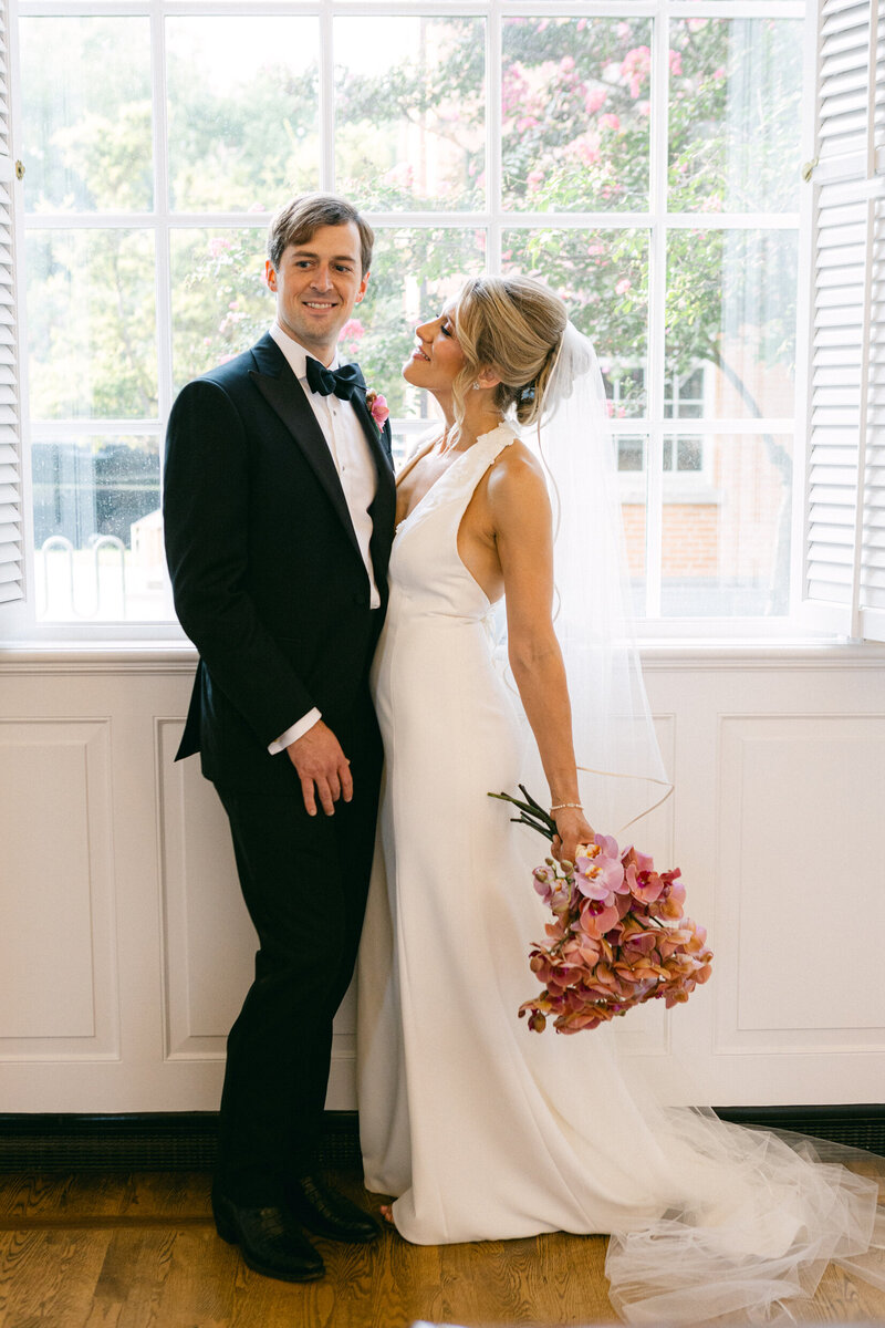 A wedding photo of a bride and groom posing for a photo