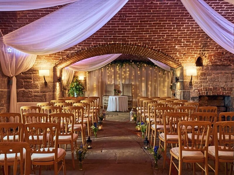 The inside of the fort set up with rows of chairs and draping from the ceiling