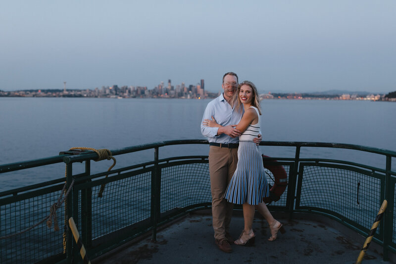 Engagement session on a Washington State Ferry with Downtown Seattle in the background.