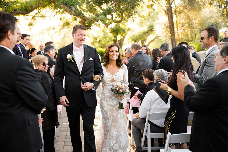 bride and groom with couple walking down the aisle