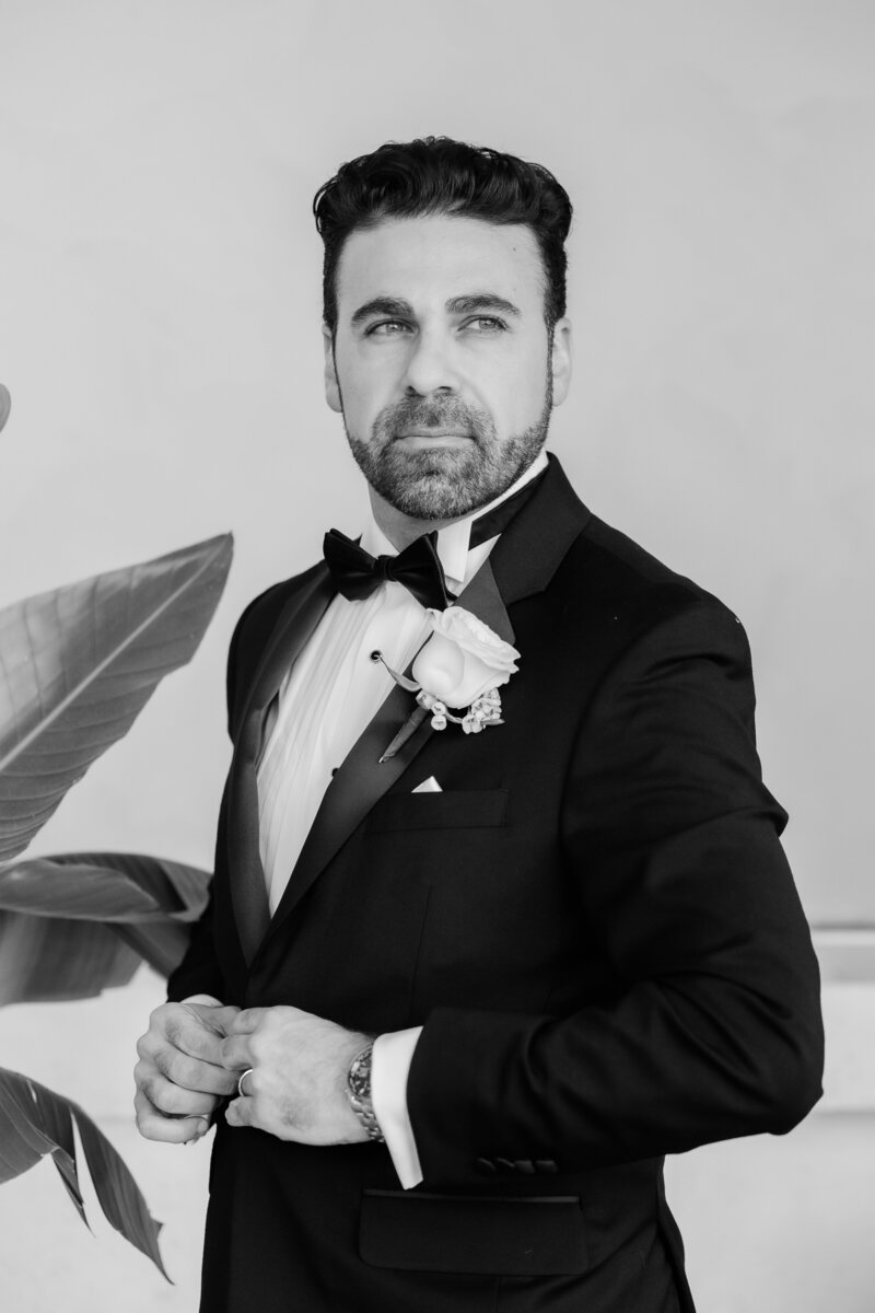 Black and white groom portrait at a wedding at the four seasons Orlando by Florida wedding photographer.