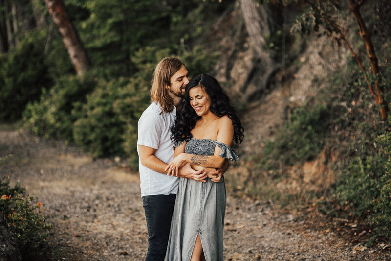 couple holding each other in the woods