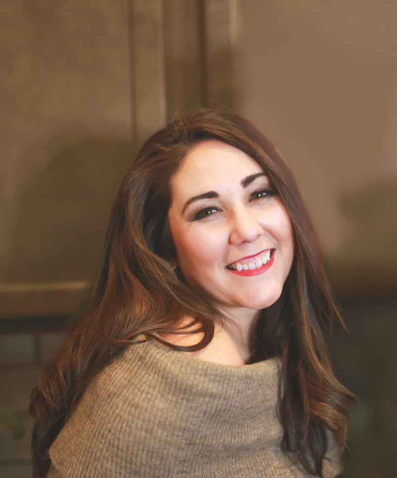Professional headshot of CEO Alia Merrill, smiling at camera