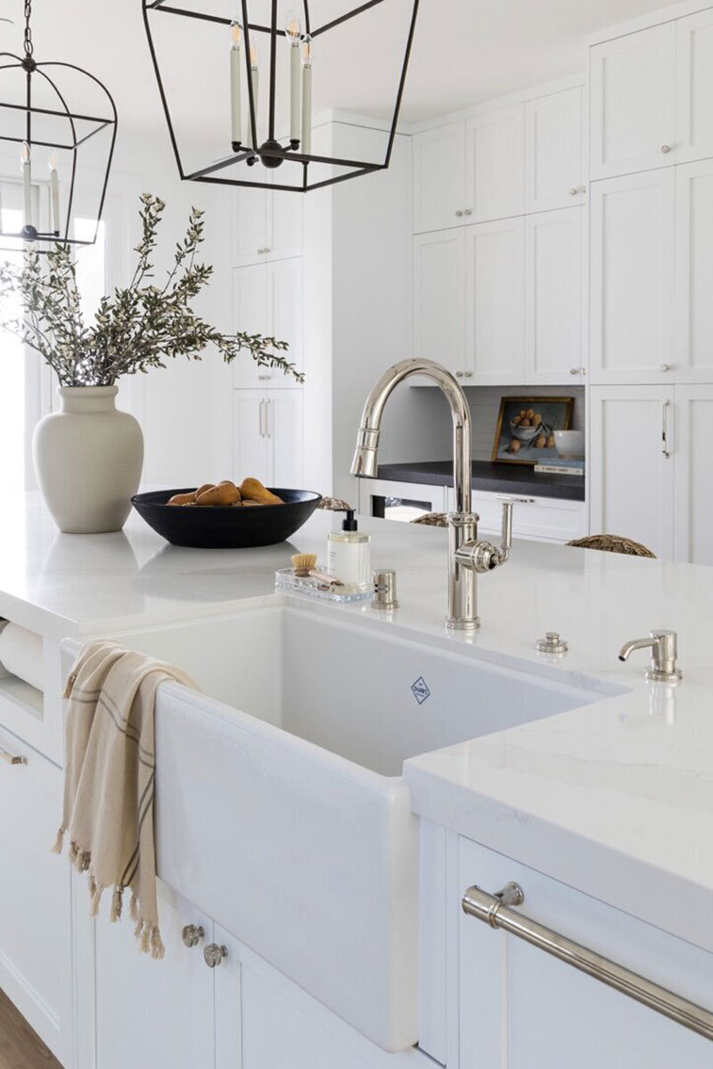 Custom kitchen featuring marble countertops and airy transitional design
