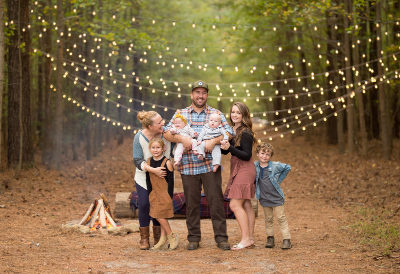 family having fun outdoors with lights in the background