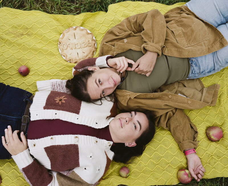 LGBTQ couple poses for engagement photo at Fishkill Farms apple orchard in the Hudson Valley