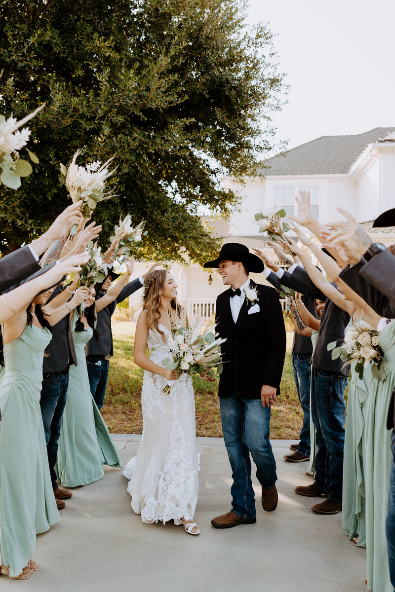 Western Wedding Photos. Bride and Groom walking, holding hands.