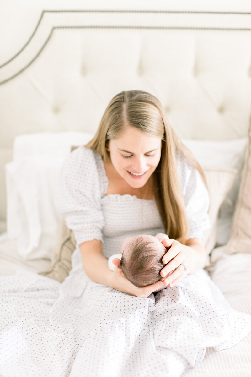 mother holding infant, kent island newborn session