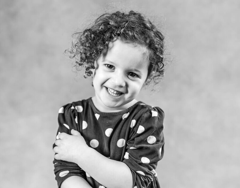 A child poses with their arms crossed.