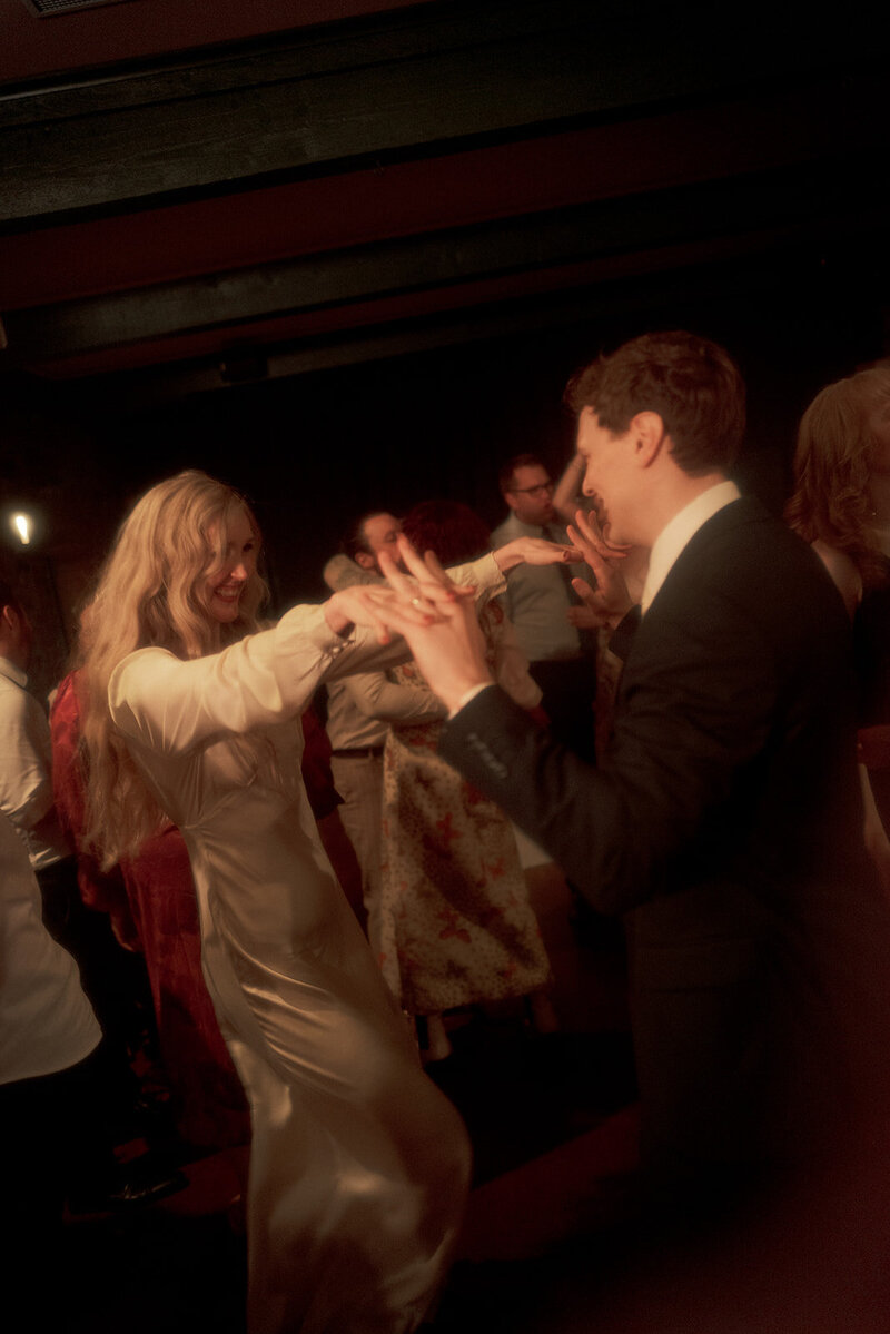 bride and groom laughing in positano on wedding day in a boat