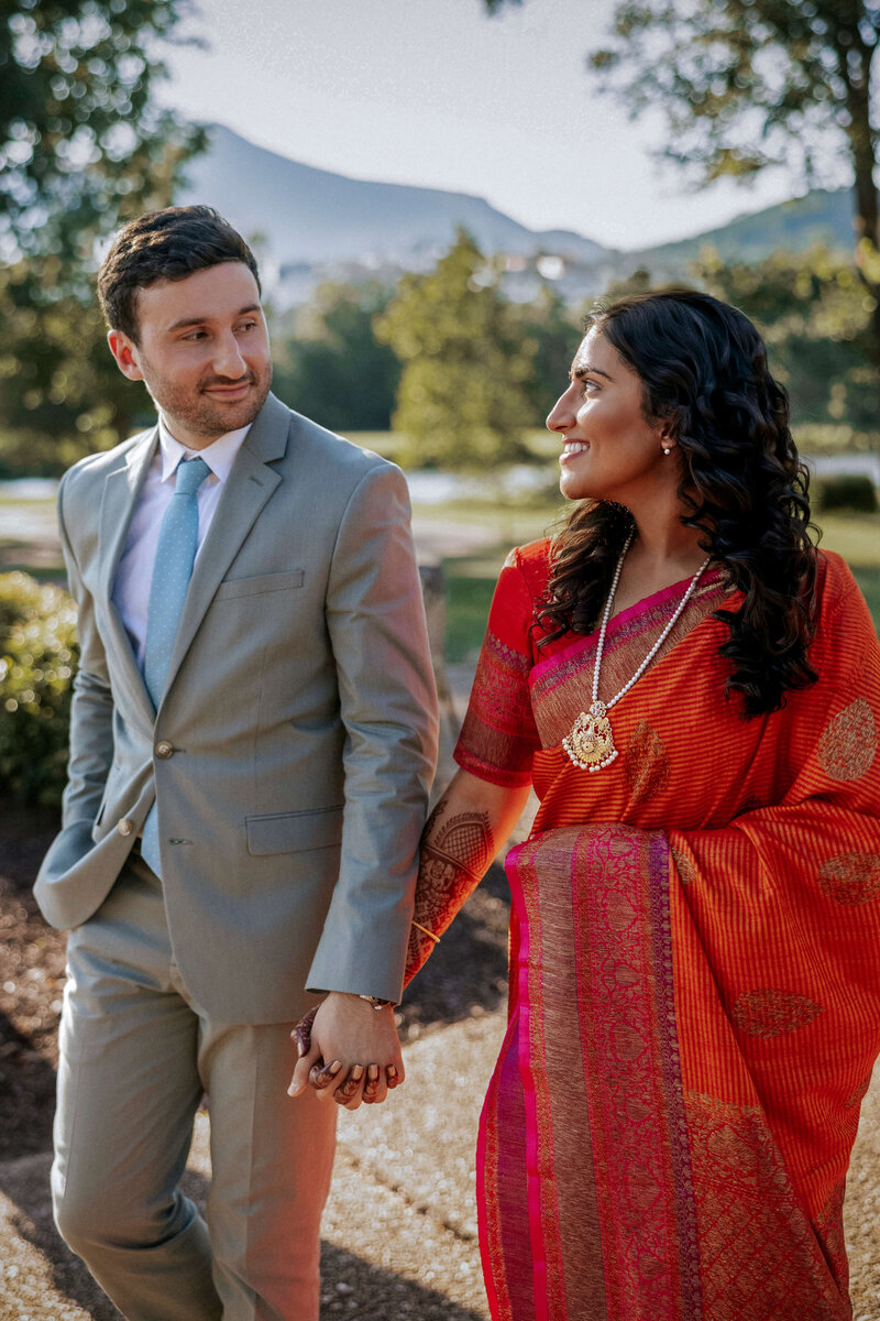 chic-multicultural-couple-holding-hands-mountains-nature