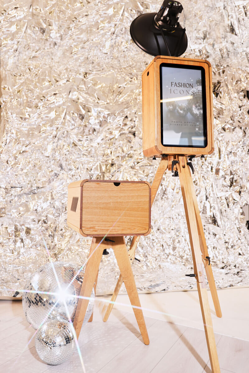 Guest during a wedding photo booth experience for a luxury event in the Oxfordshire, posing wearing curated props against a white backdrop