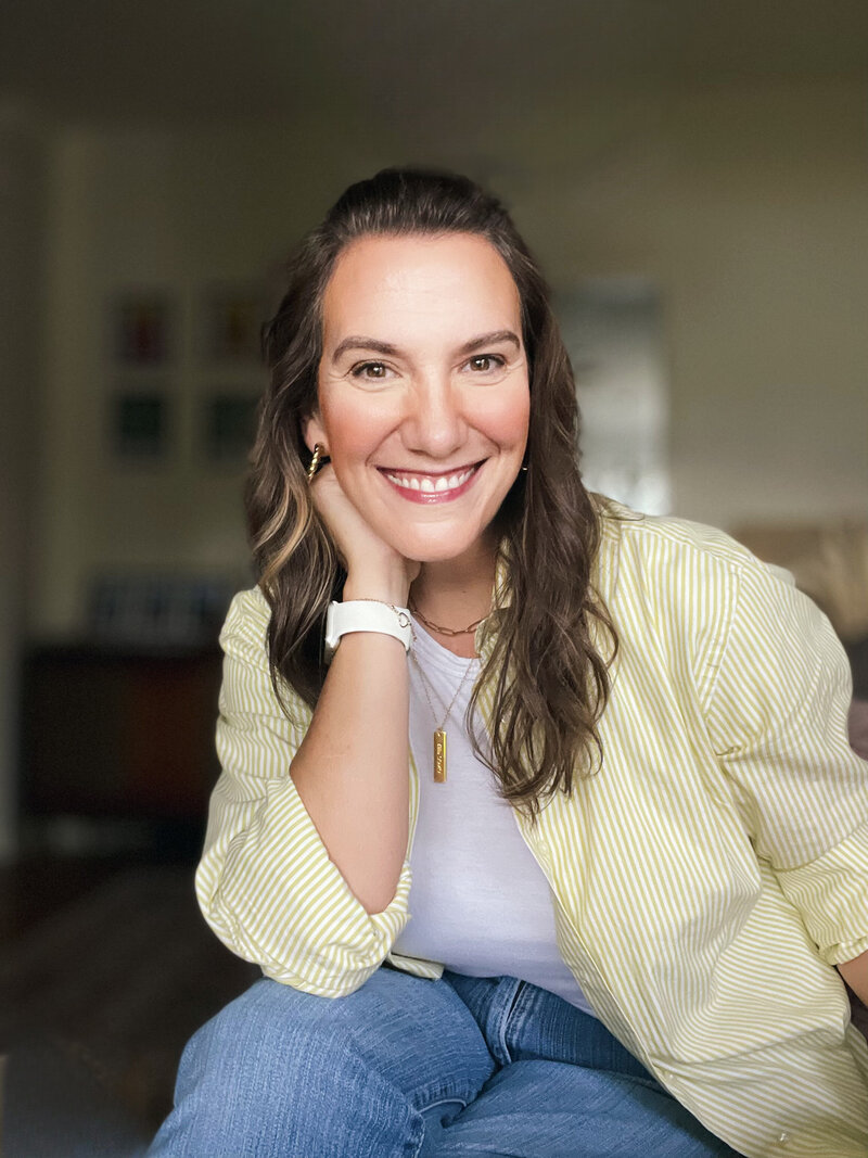 Chasity Campbell smiling looking at camera for professional headshot with white and yellow button up shirt and white t-shirt