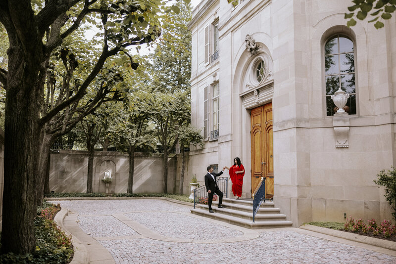 ultra-chic-couple-descending-mansion-staircase-into-stunning-open-courtyard