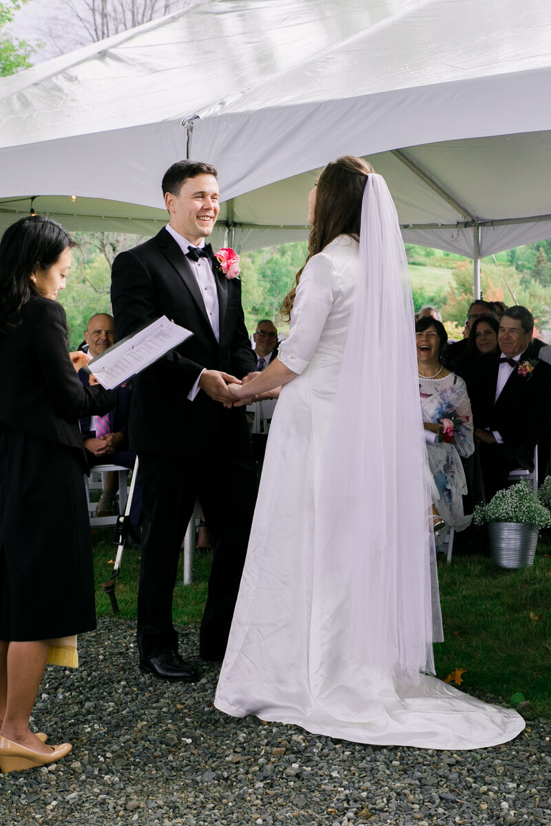 Bride and Groom holding hands during ceremony | Wedding Photography