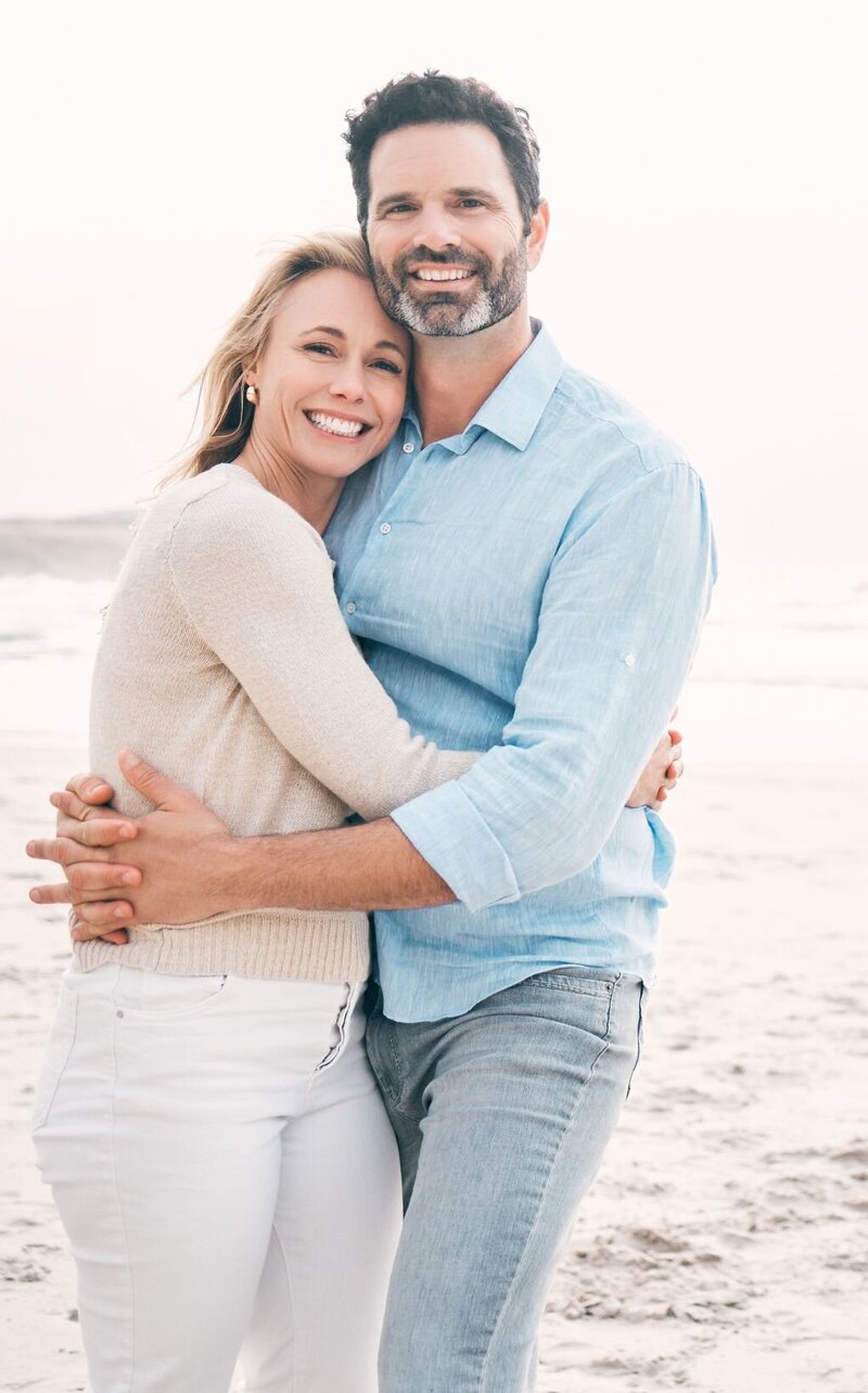 A loving couple smiling and hugging each other represents how married couples can heal from infidelity with The Affair Recovery Online Program: It's Okay To Stay by Relationship Experts