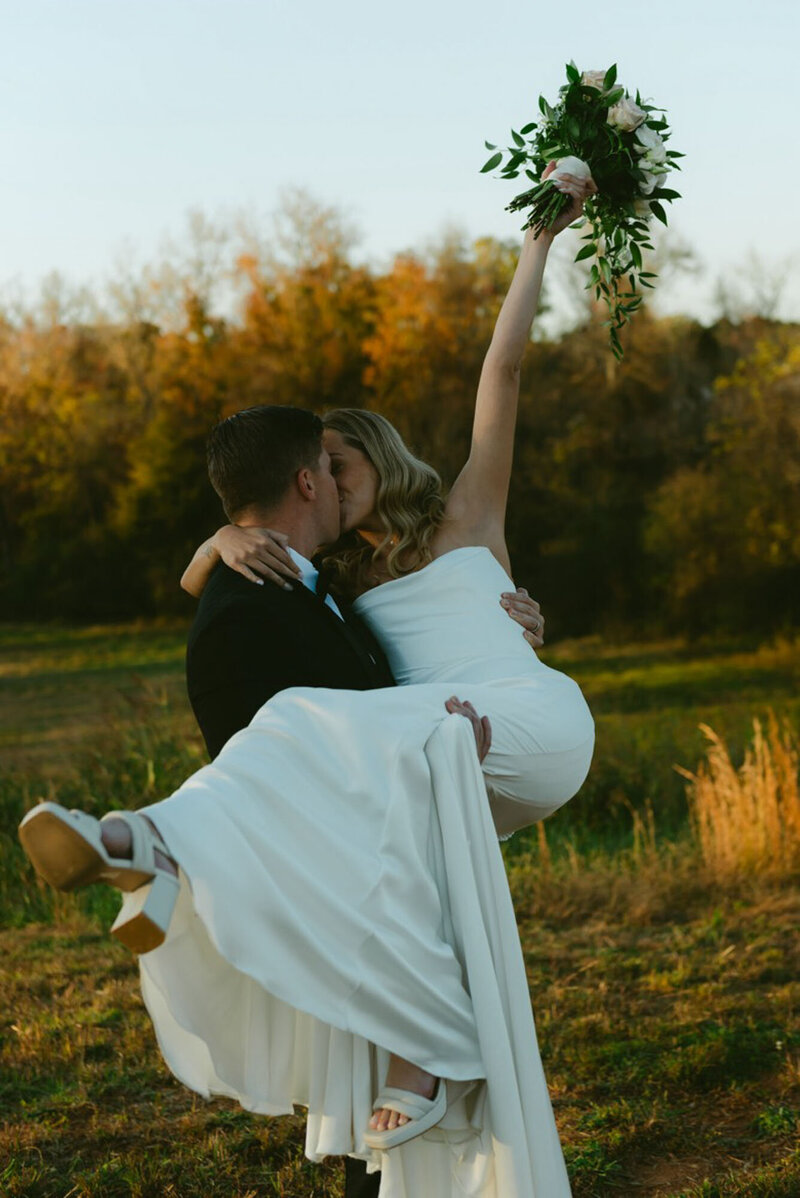 North Carolina bride holding bouquet in air at destination wedding
