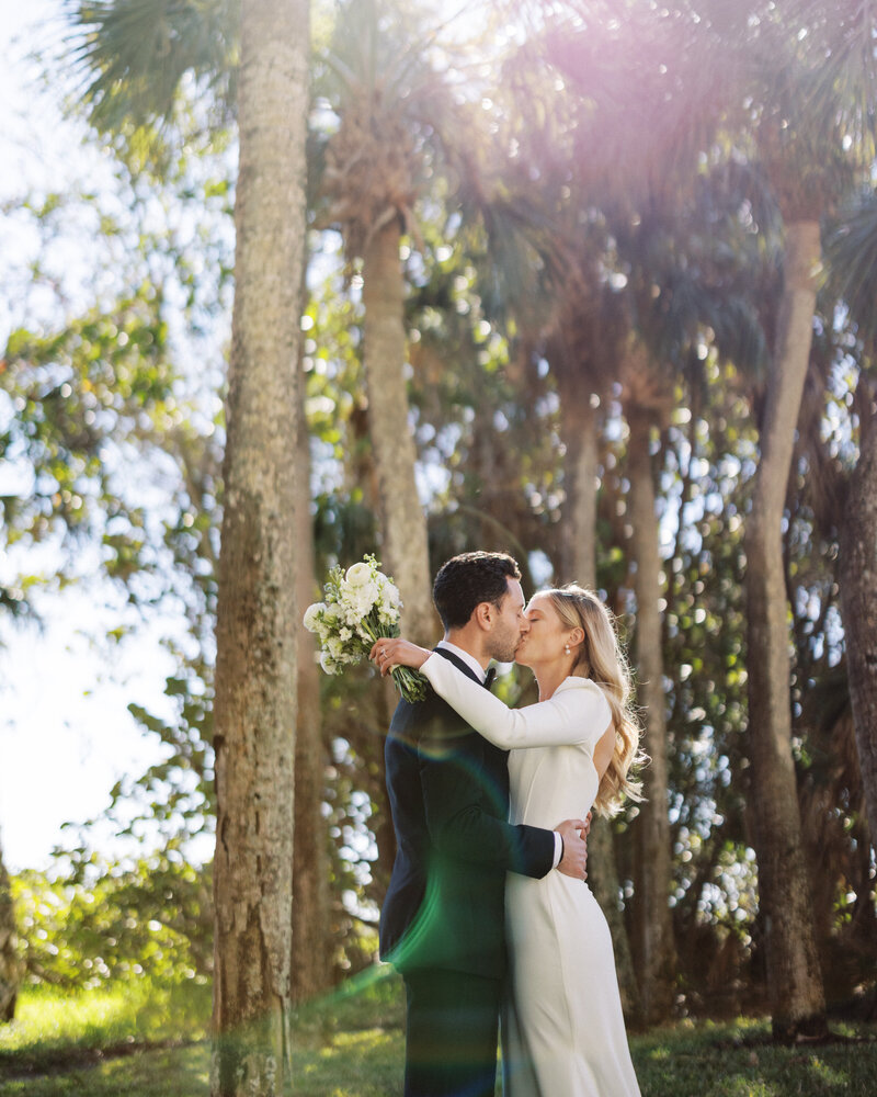 Bride and groom walk hand in hand through the woods at South Carolina Wedding Venue Waverly Place.