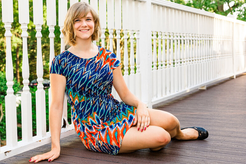 Senor girl photo session pose on fence rail with Ron Schroll Photography at Charlotte, NC