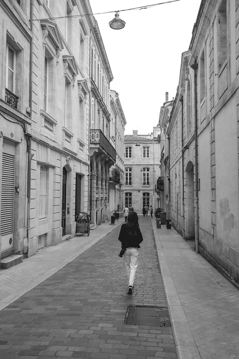 woman walking down street in europe