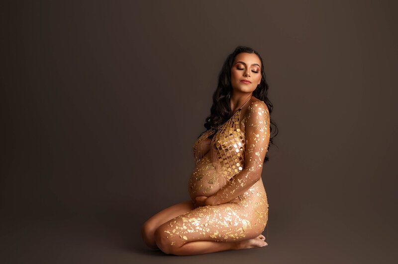 Expectant mother embraces her pregnancy belly during Maternity Photoshoot in Asheville, NC.
